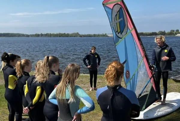Jonge cursisten krijgen windsurfles bij GearFreak Surfschool